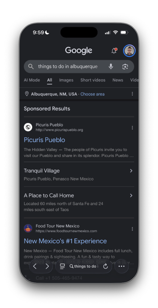The same search in dark mode. The first sponsored result is now Picuris Pueblo on picurispueblo.org, with extra links “Tranquil Village” and “A Place to Call Home: Located 60 miles north of Santa Fe and 24 miles south east of Taos”. Below it, Food Tour New Mexico, “New Mexico’s #1 Experience”.