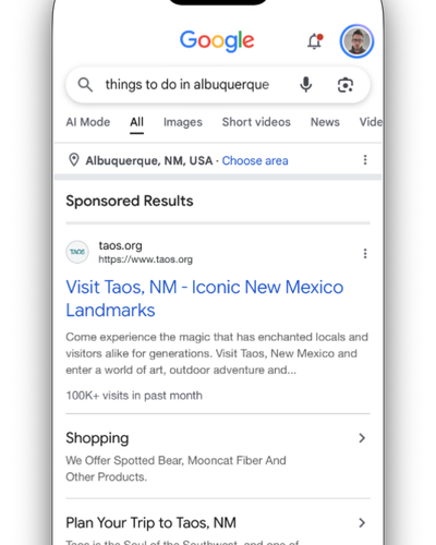 Google results on a phone for “things to do in albuquerque”, starting with a sponsored ad.
